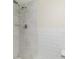 Modern bathroom with white marble tile, a rainfall shower head, and ample space at 101 Louella Ln # 11, Nokomis, FL 34275