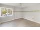 Bedroom featuring wood-look floors, a large window, and neutral walls at 101 Louella Ln # 11, Nokomis, FL 34275
