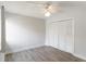 Bedroom with hardwood flooring, a ceiling fan and closet with white doors at 101 Louella Ln # 11, Nokomis, FL 34275