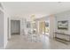 Bright, open dining area with modern table, chairs, and a view through sliding glass doors at 101 Louella Ln # 11, Nokomis, FL 34275