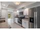 Modern kitchen with stainless steel appliances, white cabinets, granite countertops, and tile backsplash at 101 Louella Ln # 11, Nokomis, FL 34275