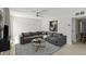Inviting living room featuring a plush gray sectional sofa and stylish geometric-patterned rug at 101 Louella Ln # 11, Nokomis, FL 34275