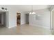 Living room area with tile flooring, a chandelier and doorway to the kitchen at 101 Louella Ln # 11, Nokomis, FL 34275