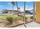 View from screened-in patio looking out at a shared community pool and manicured lawn at 101 Louella Ln # 11, Nokomis, FL 34275