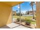 The view from the screened patio shows the green lawn and palm trees in the distance at 101 Louella Ln # 11, Nokomis, FL 34275