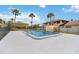 Community pool surrounded by lush palm trees and well-maintained landscaping at 101 Louella Ln # 11, Nokomis, FL 34275