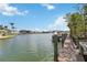 Picturesque waterfront view from a private dock, showcasing serene canal waters and beautiful homes in the distance at 101 Louella Ln # 11, Nokomis, FL 34275