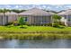 Beautiful backyard view with a screened lanai overlooking a pond and lush landscaping at 11026 Barnsley Dr, Venice, FL 34293