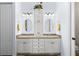 Bright bathroom with double sinks, granite countertops, ample storage, and stylish lighting fixtures at 11026 Barnsley Dr, Venice, FL 34293