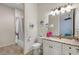 Well-lit bathroom features a tub and shower combo, decorative mirror and updated vanity at 11026 Barnsley Dr, Venice, FL 34293
