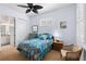 Comfortable bedroom features ceiling fan, closet and decoratively matched furnishings, plus ensuite bathroom at 11026 Barnsley Dr, Venice, FL 34293