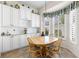 Cozy breakfast nook with a wooden table, upholstered chairs, and natural light from a window at 11026 Barnsley Dr, Venice, FL 34293