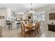 Dining room with chandelier and an open view to the kitchen at 11026 Barnsley Dr, Venice, FL 34293
