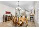 Dining room with chandelier and an open view to the kitchen and living spaces at 11026 Barnsley Dr, Venice, FL 34293