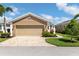 Inviting home featuring a paved driveway, two-car garage, and well-maintained landscaping at 11026 Barnsley Dr, Venice, FL 34293