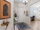 Inviting home foyer with tile floors, stylish decor, and a glimpse of a home office at 11026 Barnsley Dr, Venice, FL 34293
