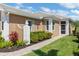 Charming home exterior featuring well maintained landscaping, white trim and tile roof at 11026 Barnsley Dr, Venice, FL 34293