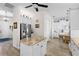 Spacious open kitchen with white cabinets, an island, stainless steel refrigerator and breakfast area at 11026 Barnsley Dr, Venice, FL 34293