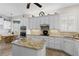 Bright kitchen with white cabinets, granite counters, stainless steel appliances, and center island at 11026 Barnsley Dr, Venice, FL 34293