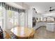 Bright kitchen and breakfast nook featuring white cabinets, granite counters, and stainless appliances at 11026 Barnsley Dr, Venice, FL 34293