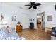 Inviting living room featuring a ceiling fan, wood floors, and views to the dining room and foyer at 11026 Barnsley Dr, Venice, FL 34293