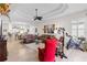 Living room with high ceilings, fan, and view of dining room and kitchen at 11026 Barnsley Dr, Venice, FL 34293