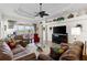 Living room with high ceilings, fan, and access to patio with lake view at 11026 Barnsley Dr, Venice, FL 34293