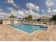 Community pool featuring a sun deck, seating and well-maintained landscaping at 11026 Barnsley Dr, Venice, FL 34293