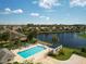 Community pool, perfect for relaxing, surrounded by beautiful landscaping and lake views at 11026 Barnsley Dr, Venice, FL 34293