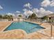 Community pool featuring a sun deck, seating and well-maintained landscaping at 11026 Barnsley Dr, Venice, FL 34293