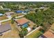 Aerial view showcasing a home with a screened-in pool, surrounded by green landscaping and a white fence at 11153 Deerwood Ave, Englewood, FL 34224
