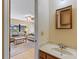 Bathroom featuring a sink, and partial view of the living room at 11153 Deerwood Ave, Englewood, FL 34224