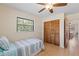 Inviting bedroom featuring hardwood floors, ceiling fan, window, and closet at 11153 Deerwood Ave, Englewood, FL 34224