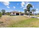 Charming single-story home with a spacious front yard, long driveway, and mature palm trees at 11153 Deerwood Ave, Englewood, FL 34224