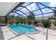Private in-ground swimming pool with a screen enclosure and well-maintained landscaping at 11153 Deerwood Ave, Englewood, FL 34224