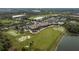 An aerial view showcases the clubhouse, golf course, and lush landscapes of this golf community at 115 Babbling Brook Run, Bradenton, FL 34212