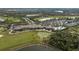 This aerial shot captures the clubhouse, pool, golf course, lake and meticulously landscaped grounds in the community at 115 Babbling Brook Run, Bradenton, FL 34212