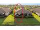 Aerial shot of a home with a screened lanai and manicured lawn in a residential community at 115 Babbling Brook Run, Bradenton, FL 34212