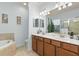 Bright bathroom with double vanity, garden tub, neutral color palette, and decorative accents at 115 Babbling Brook Run, Bradenton, FL 34212