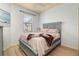 Cozy bedroom with grey bed frame, complemented by light-toned walls, and a window with natural light at 115 Babbling Brook Run, Bradenton, FL 34212