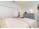 Bedroom with light blue walls, neutral bedding, and access to a bathroom at 115 Babbling Brook Run, Bradenton, FL 34212