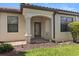Covered front porch with brick walkway, decorative columns and arched entry at 115 Babbling Brook Run, Bradenton, FL 34212