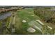 Beautiful aerial view of the golf course with lush green grass and a distant golf cart at 115 Babbling Brook Run, Bradenton, FL 34212