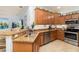 Updated kitchen with granite countertops, stainless steel appliances, and wood cabinetry perfect for cooking and entertaining at 115 Babbling Brook Run, Bradenton, FL 34212