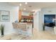 Well-lit kitchen with granite countertops, stainless appliances, and counter seating for casual dining and entertaining at 115 Babbling Brook Run, Bradenton, FL 34212