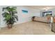 Bright living room with tile floors and comfortable seating near a large window at 115 Babbling Brook Run, Bradenton, FL 34212