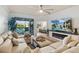 Inviting living room features a large sectional, modern fireplace, and access to outdoor balcony seating and views at 115 Babbling Brook Run, Bradenton, FL 34212