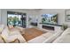 Living room with a sectional sofa, fireplace, and access to the screened lanai at 115 Babbling Brook Run, Bradenton, FL 34212