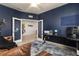 Inviting home office with blue accent wall, french doors, and modern desk setup at 115 Babbling Brook Run, Bradenton, FL 34212