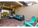 Covered outdoor patio with comfortable seating and stylish decor at 115 Babbling Brook Run, Bradenton, FL 34212